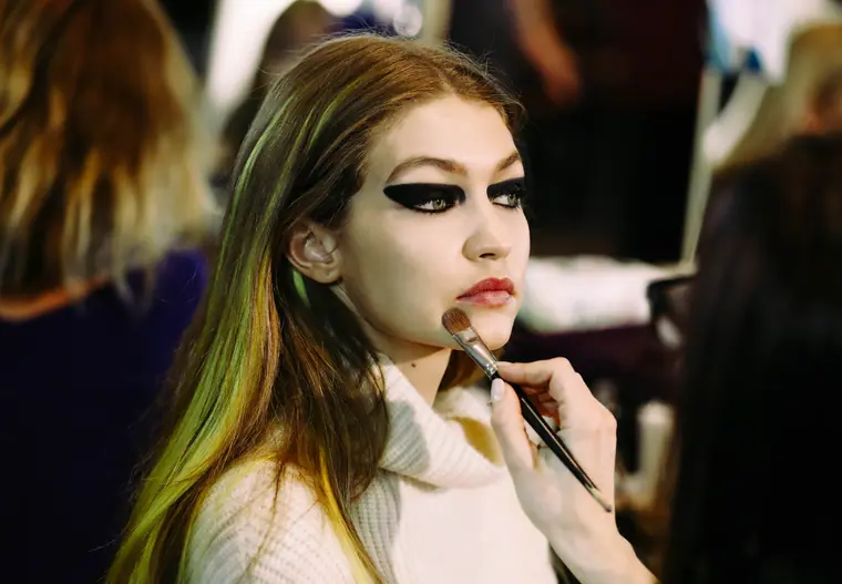 Gigi Hadid: a model receiving dramatic eye make-up backstage