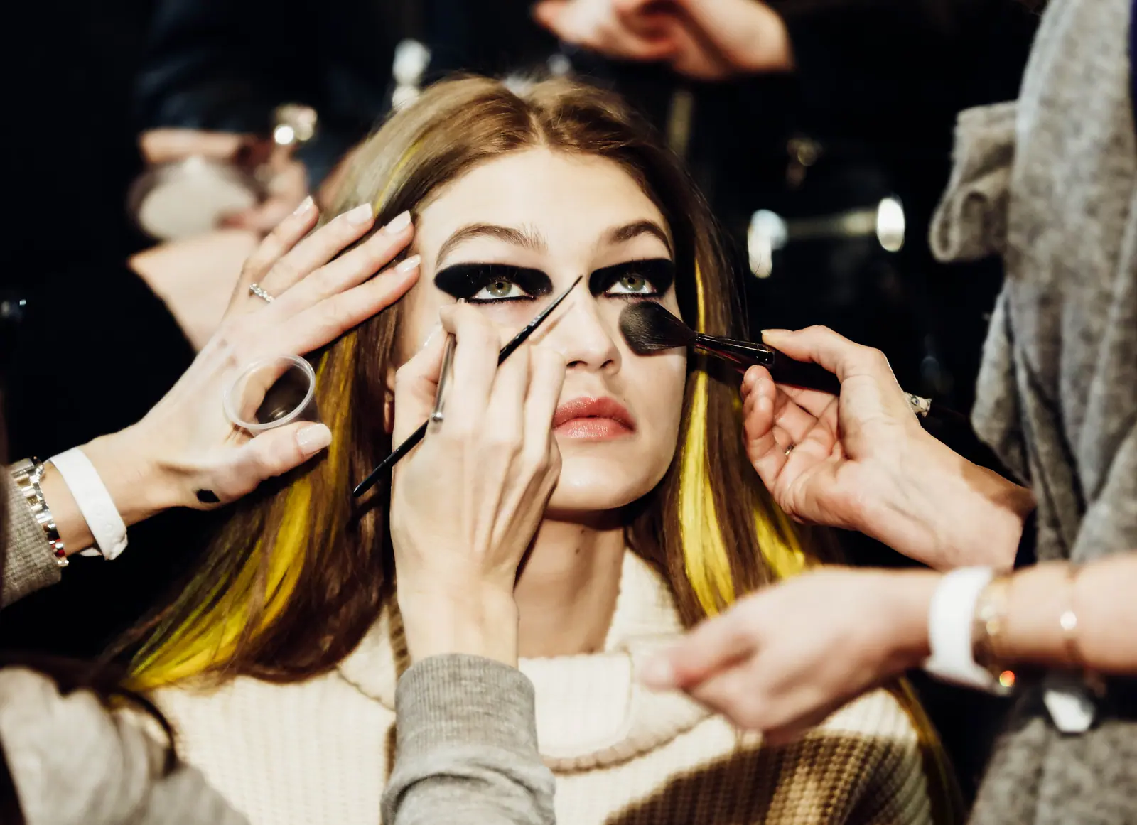 Gigi Hadid having her eye make-up applied